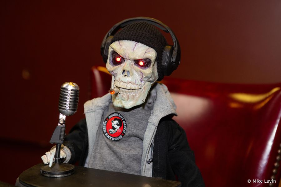 Deadman close up on the mic, red eyes glowing
