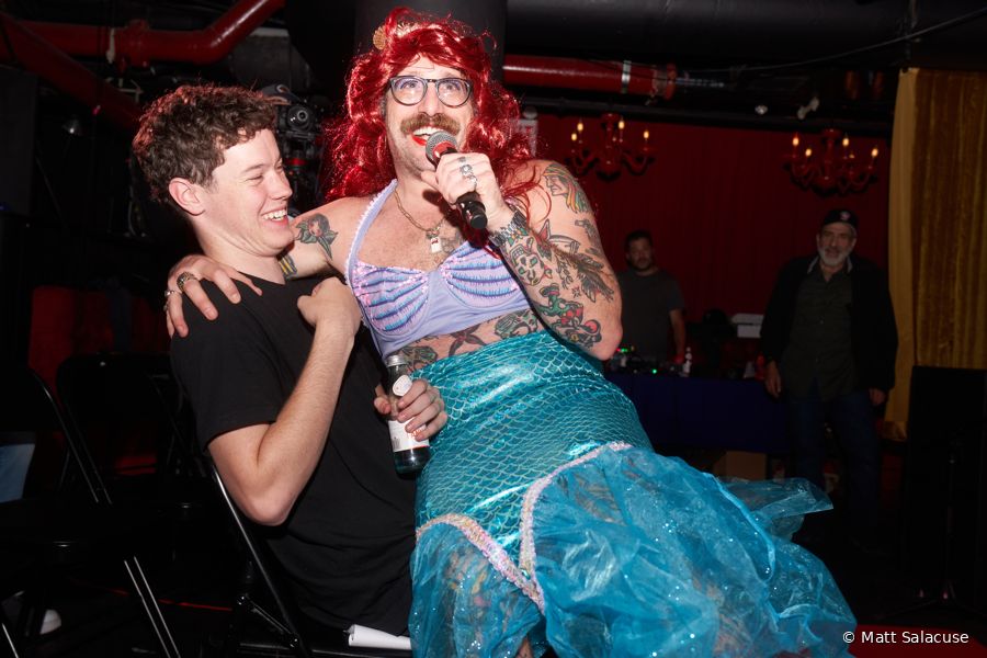 A costumed contestant grabs the mic